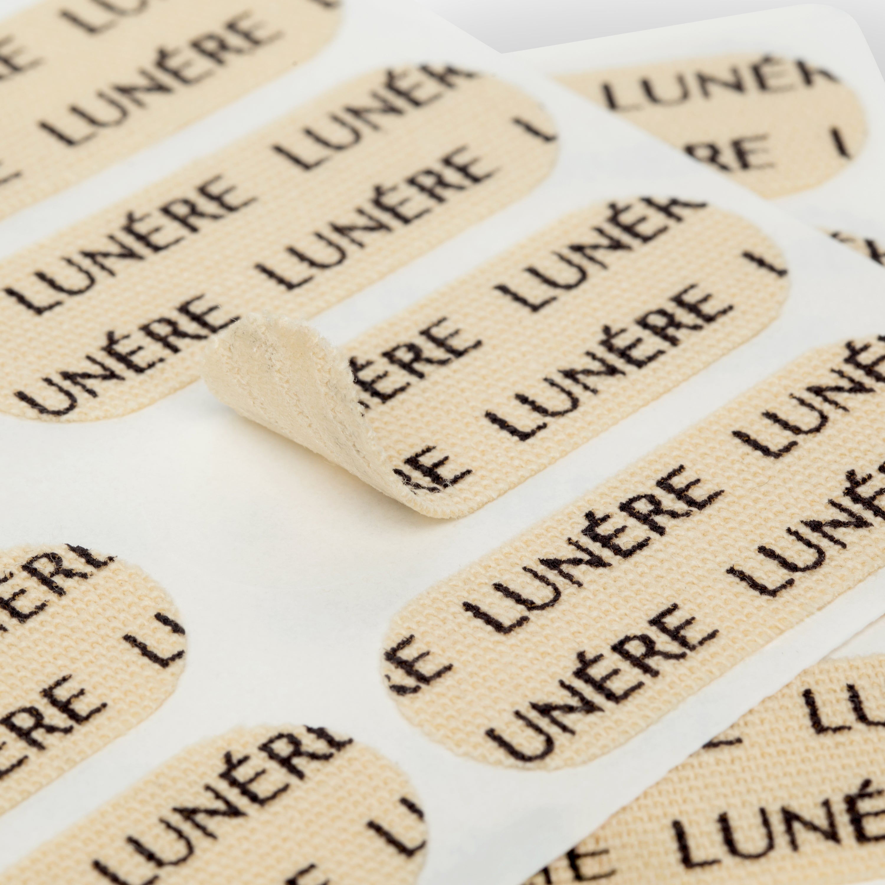 LUNÉRE peptide-infused face tape patches on a sheet, designed for overnight skin support and smoothing.